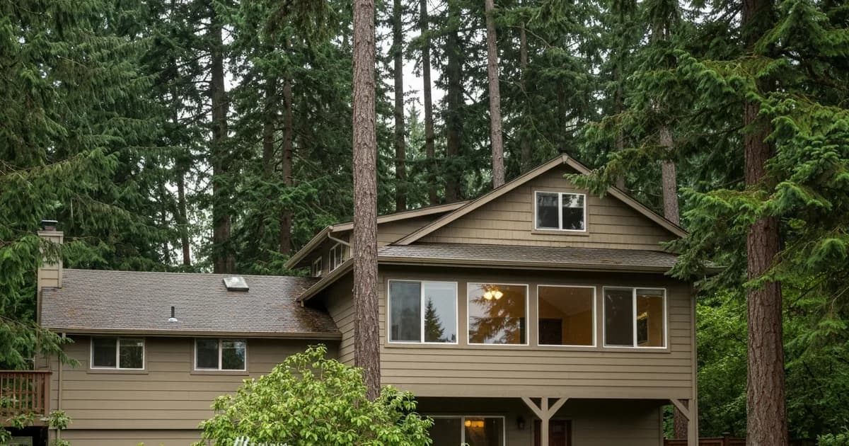 Streak-free windows on a two-story Pacific Northwest home surrounded by Douglas firs in Covington, WA